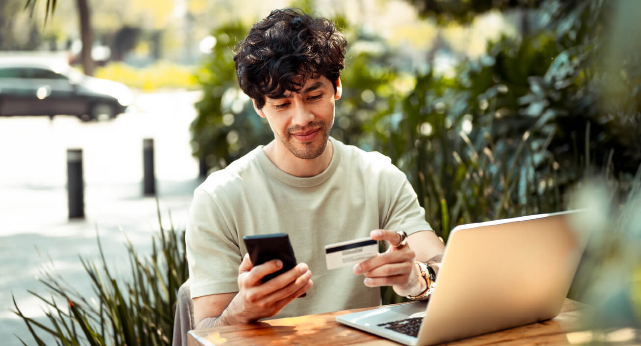 A young man makes sure to pay his bills on time after learning how to save money in college.