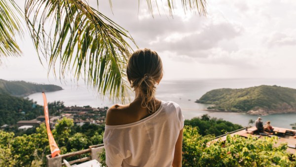 Women's back against a tropical island