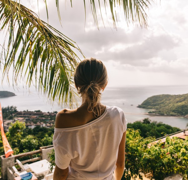 Women's back against a tropical island