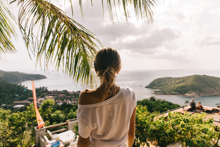 Women's back against a tropical island