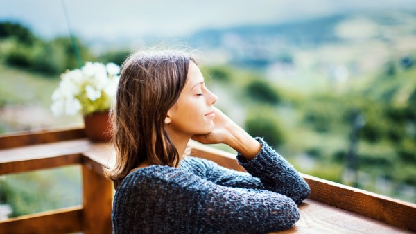 woman relaxing on balcony outdoors