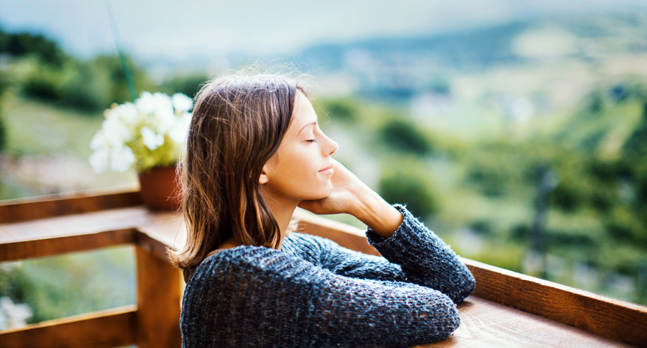 woman relaxing on balcony outdoors