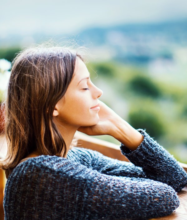 woman relaxing on balcony outdoors