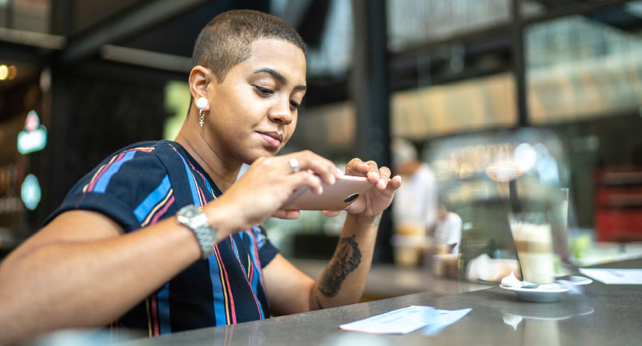 A young professional deposits their check to find an answer to the question of “how long does it take for a check to clear?”