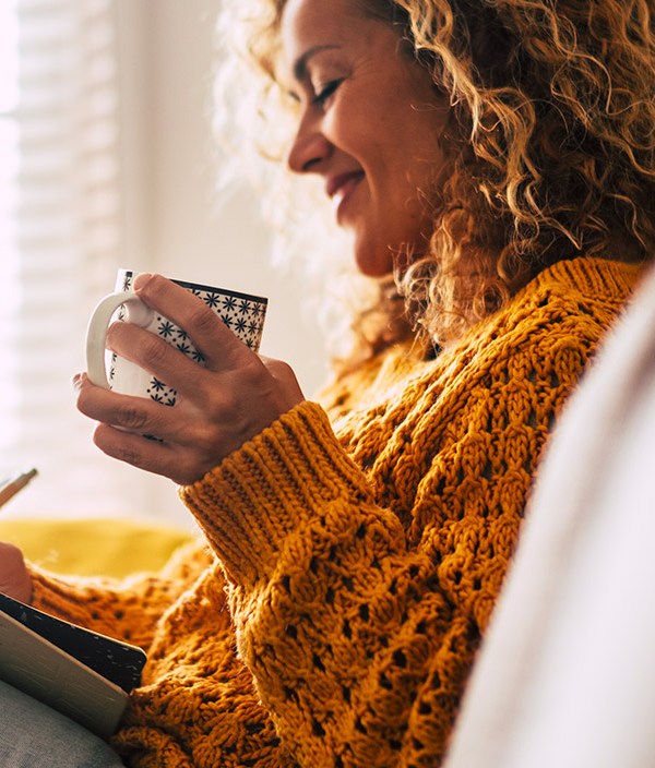 woman journaling with coffee