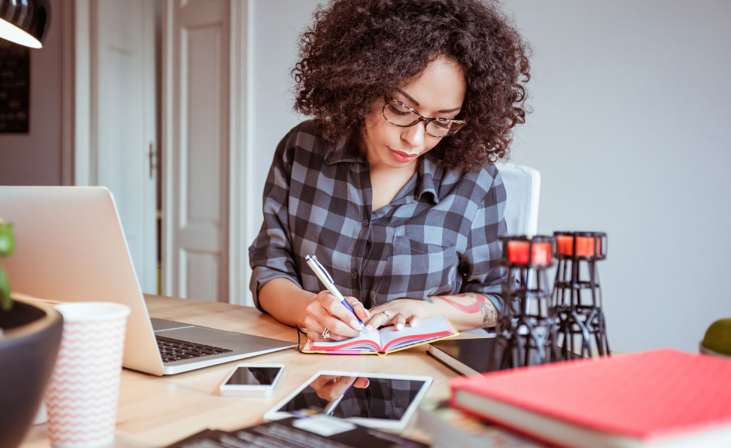 A woman sorts through her finances to learn how to invest properly, one of many passive income ideas she has.