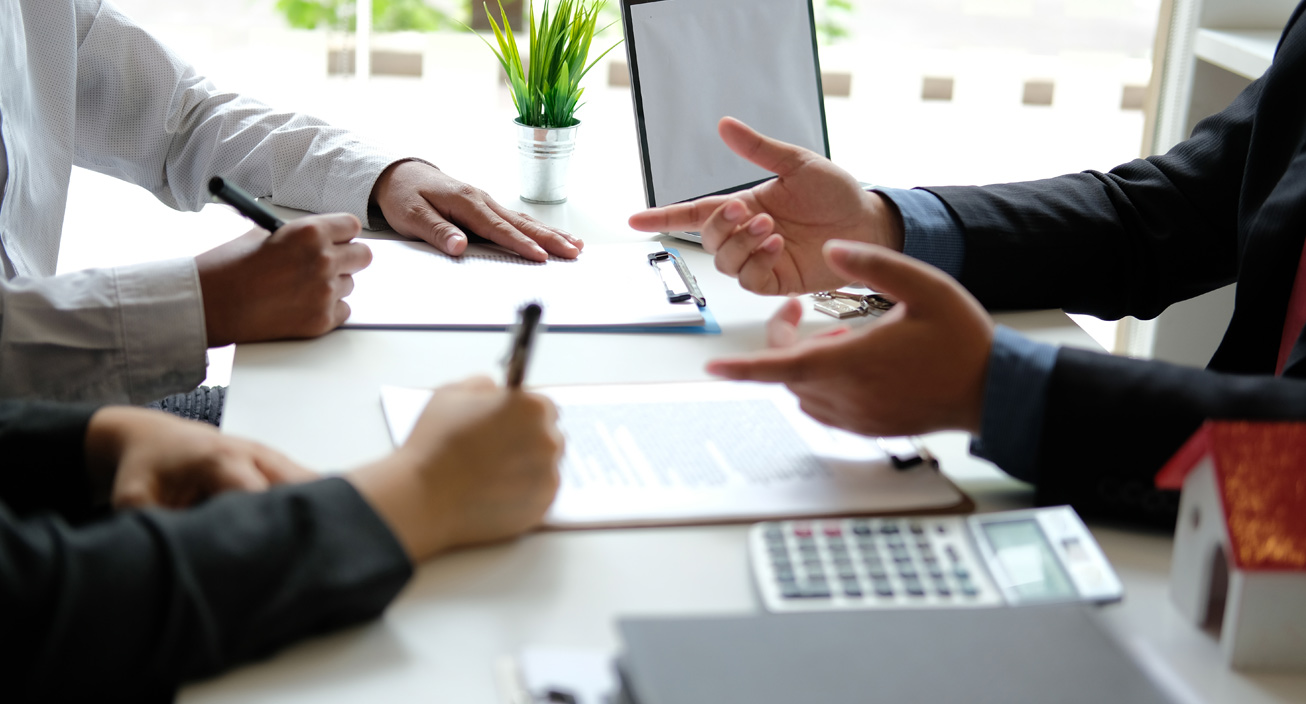 two people talking over document