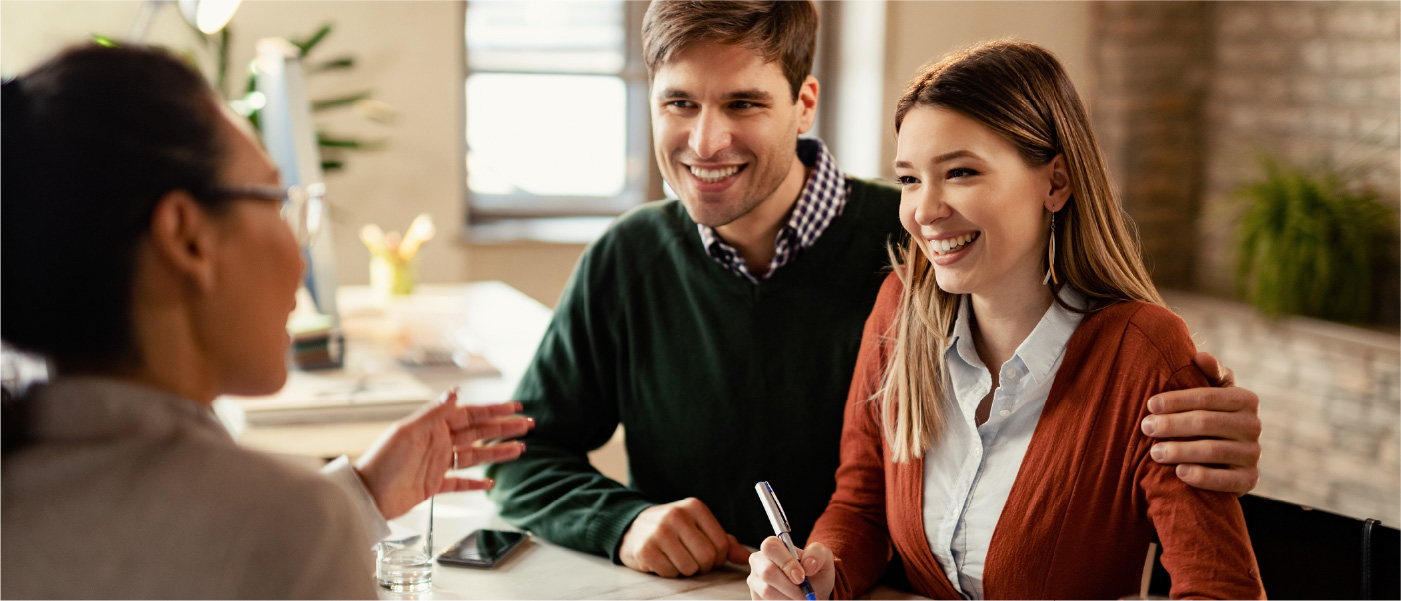 A couple meets with a real estate agent to ask the common question of “how long does it take to refinance a house?”