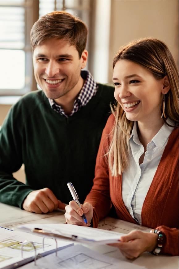 A couple meets with a real estate agent to ask the common question of “how long does it take to refinance a house?”