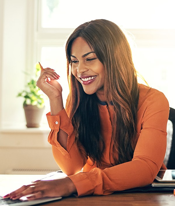 Woman sitting at laptop smiling