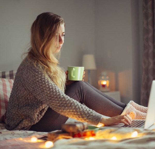 Woman working in bed on a laptop