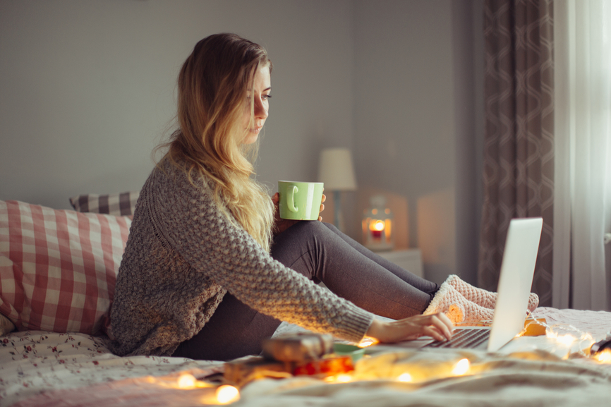 Woman working in bed on a laptop