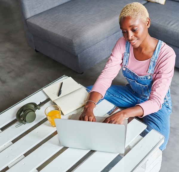 Smiling Woman Using A Laptop At Home