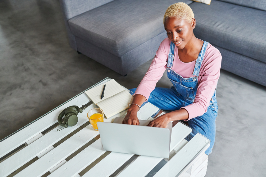 Smiling Woman Using A Laptop At Home