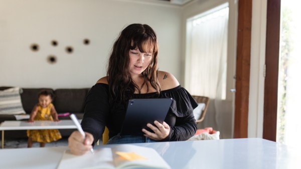 Young Woman Uses Tablet at a desk