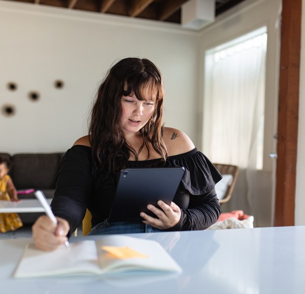 Young Woman Uses Tablet at a desk