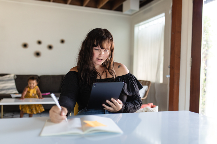 Young Woman Uses Tablet at a desk