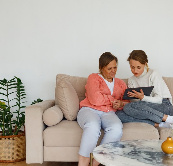 Mother And Daughter Watching Video On Tablet