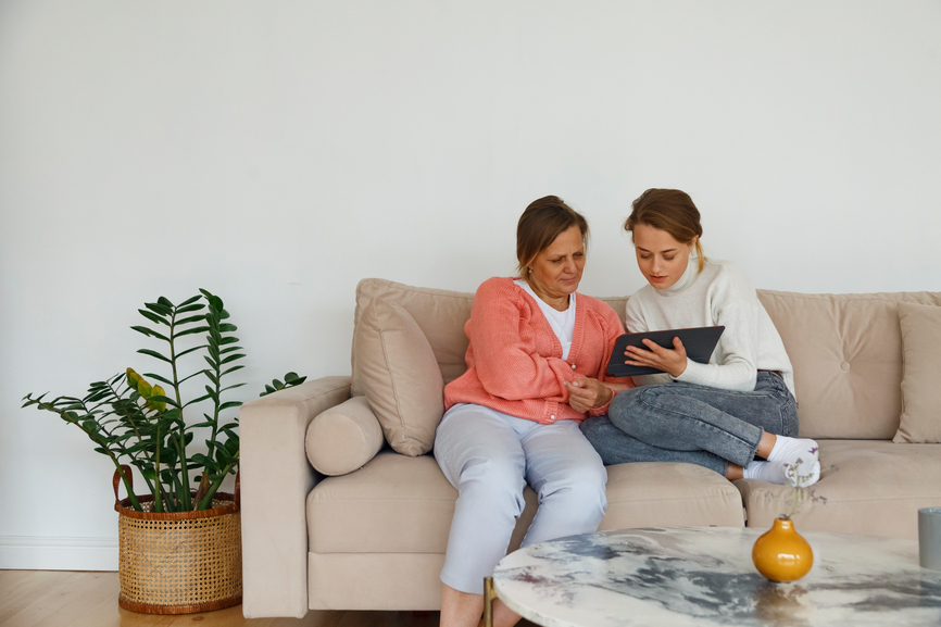 Mother And Daughter Watching Video On Tablet