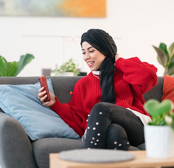 Woman In Hijab Smiling and FaceTiming on her Phone