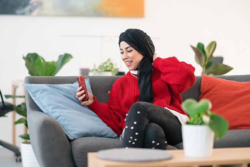 Woman In Hijab Smiling and FaceTiming on her Phone