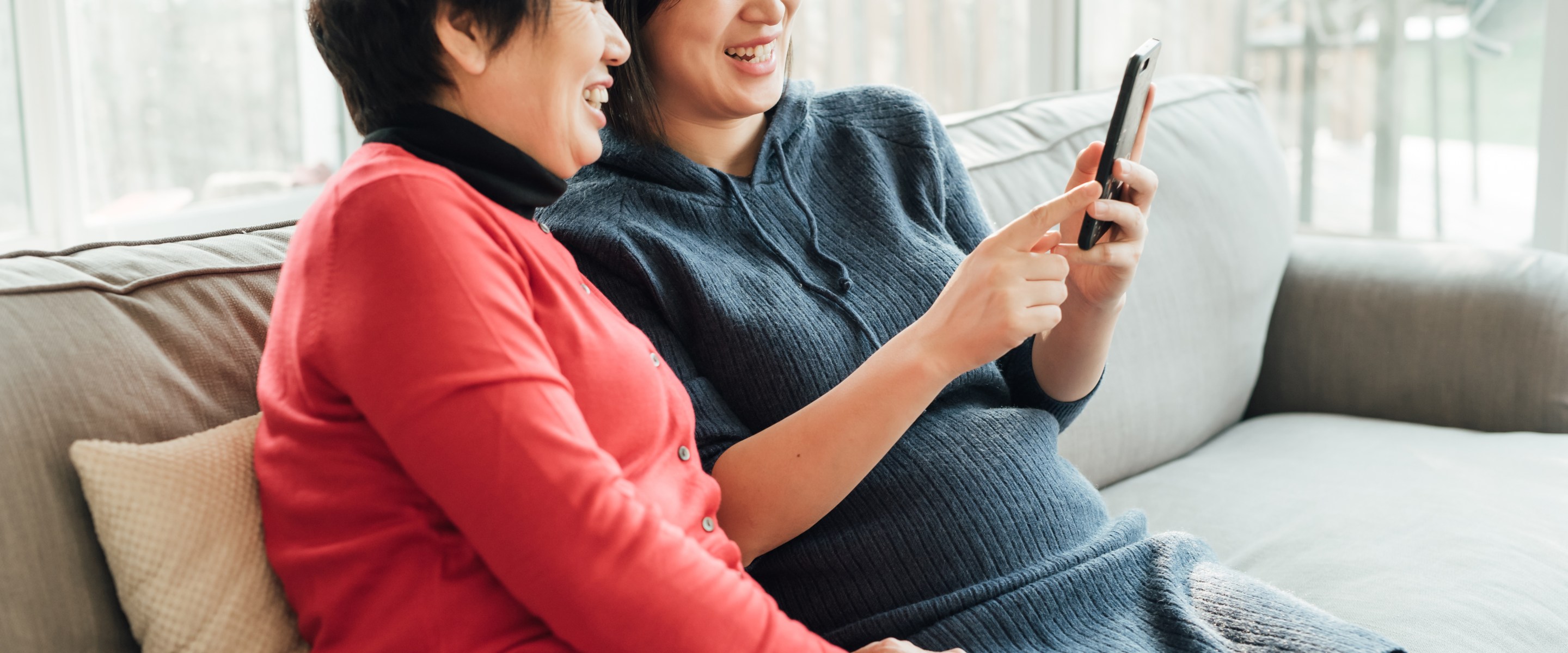 Mother and daughter using smartphone