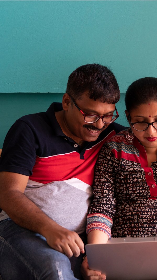 Indian Couple With Laptop Inside Room