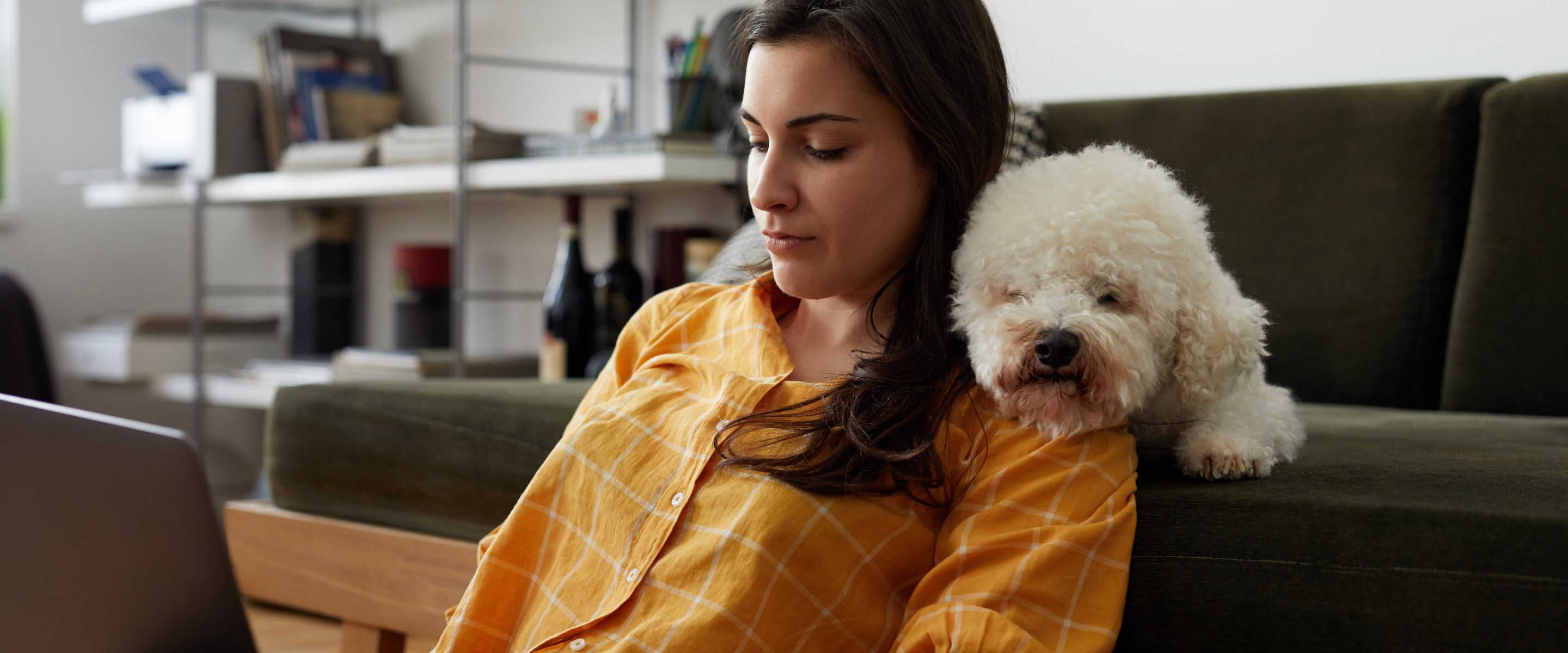 Woman on laptop with dog