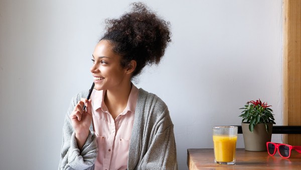 smiling-woman-thinking-looking-out-of-window