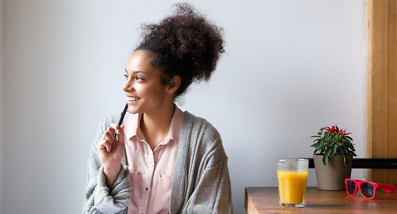 smiling-woman-thinking-looking-out-of-window