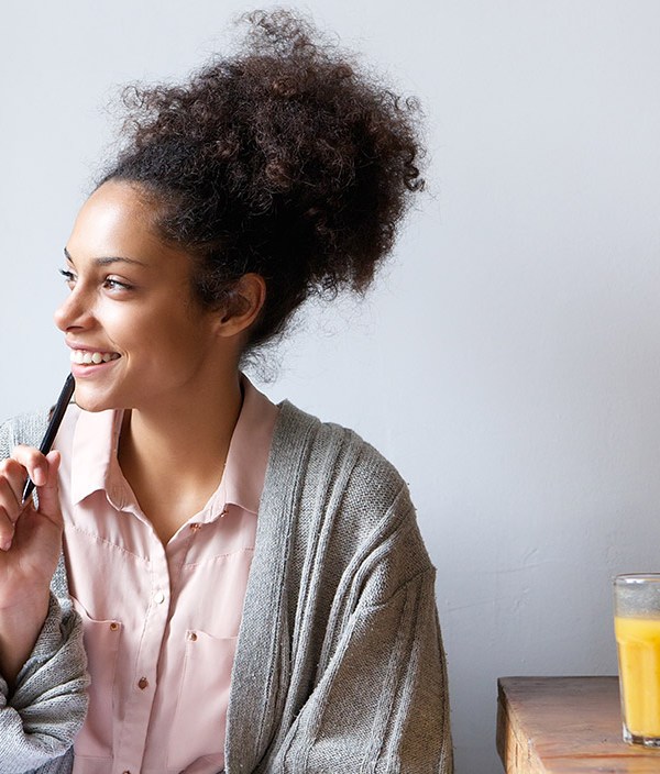 smiling-woman-thinking-looking-out-of-window