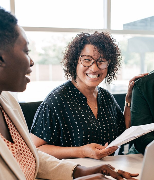 two-women-and-man-going-over-paper-work