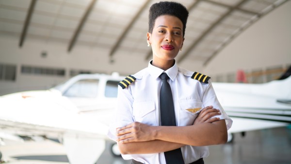 airplane-pilot-woman-hangar-confident