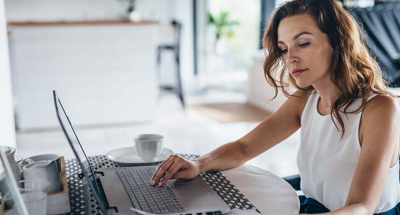 woman-working-at-computer-looking-at-finances