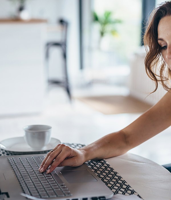 woman-working-at-computer-looking-at-finances