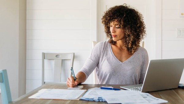 woman-finances-expenses-laptop-paperwork