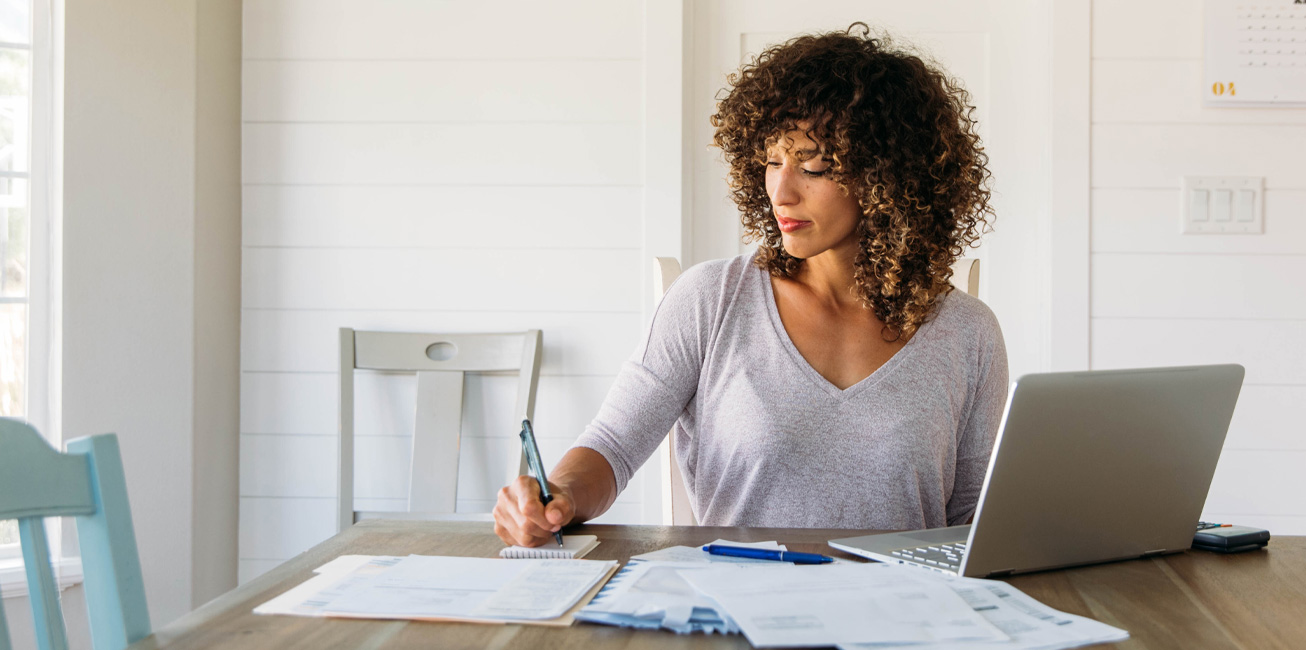 woman-finances-expenses-laptop-paperwork