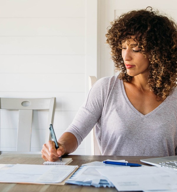 woman-finances-expenses-laptop-paperwork