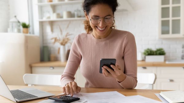 Woman looks over her medical bills and negotiates with the hospital over the phone