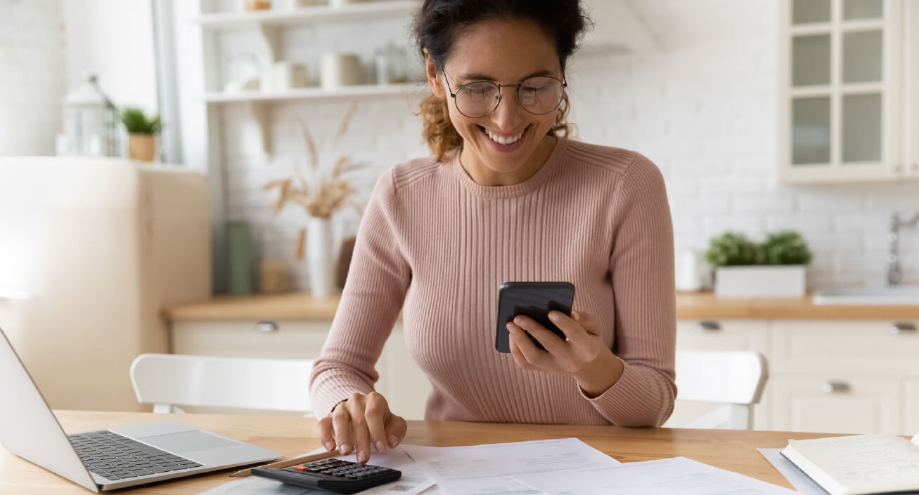 Woman looks over her medical bills and negotiates with the hospital over the phone