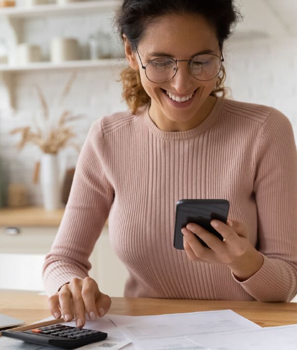 Woman looks over her medical bills and negotiates with the hospital over the phone