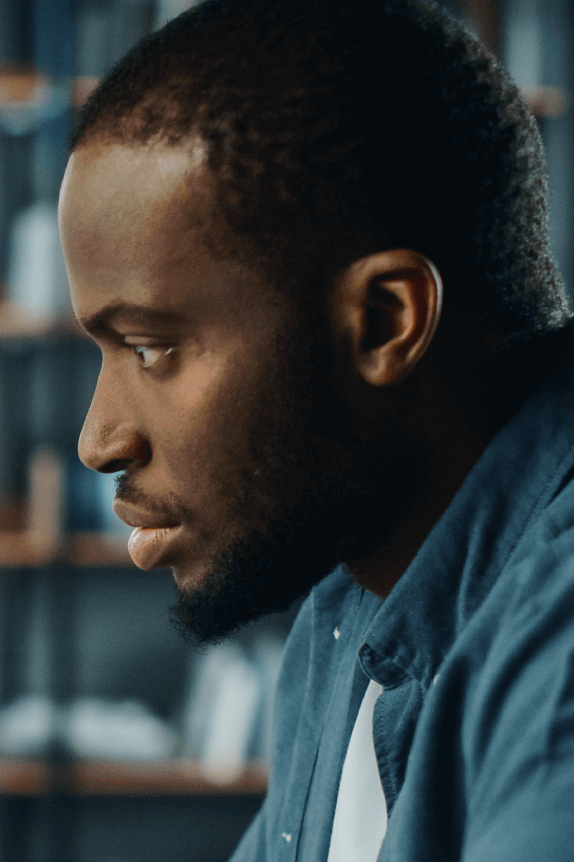 A Black man appears to be reviewing financial documents, indicating he might be a financial advisor, one of the best self-empoyed jobs.