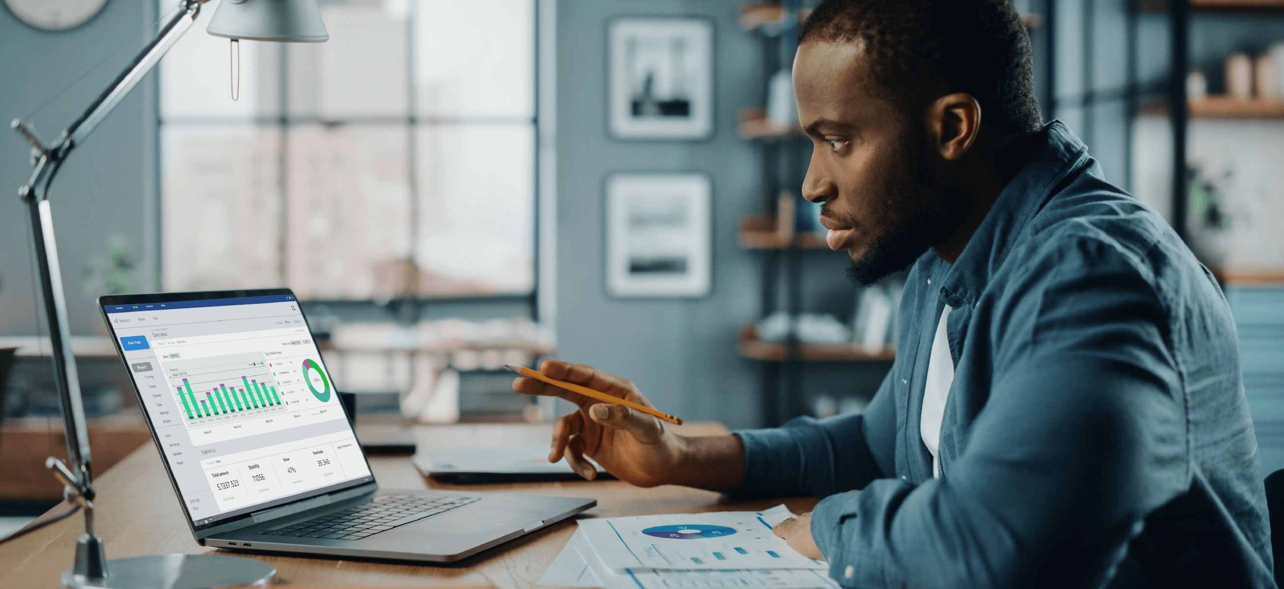 A Black man appears to be reviewing financial documents, indicating he might be a financial advisor, one of the best self-empoyed jobs.