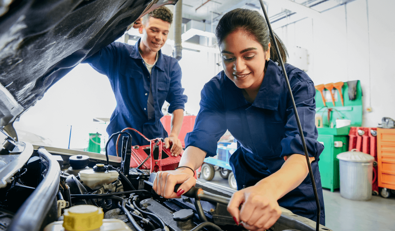 A woman is working under the hood of a char, indicating she may be a mechanic, one of the best self-empoyed jobs.