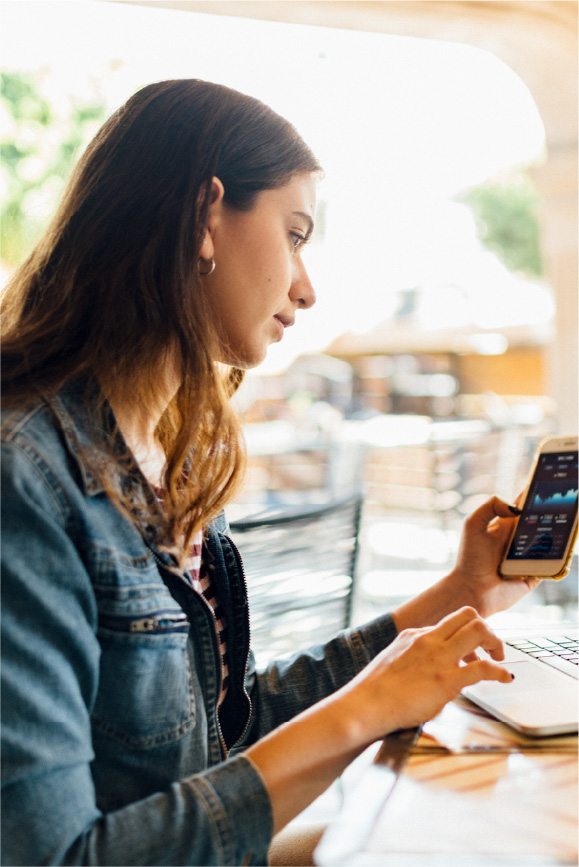 While researching crypto on her phone, a woman asks herself, “how does cryptocurrency work?”