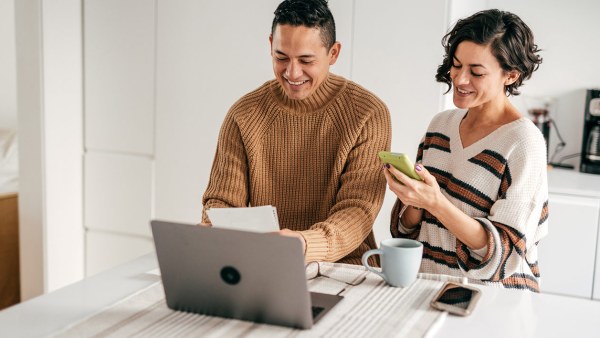 Smiling couple calculating finances.