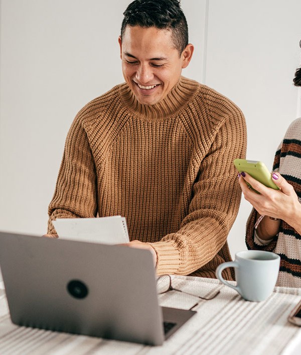 Smiling couple calculating finances.