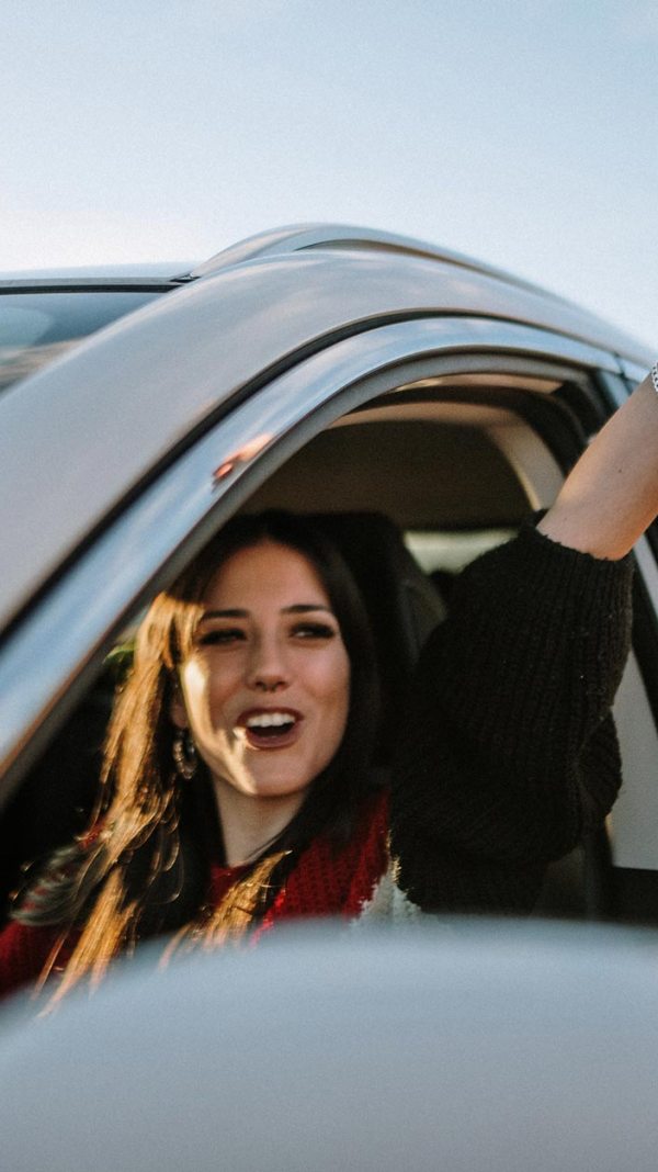 Woman holding keys in car