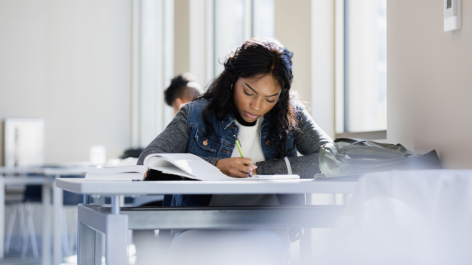 A young woman studying a book