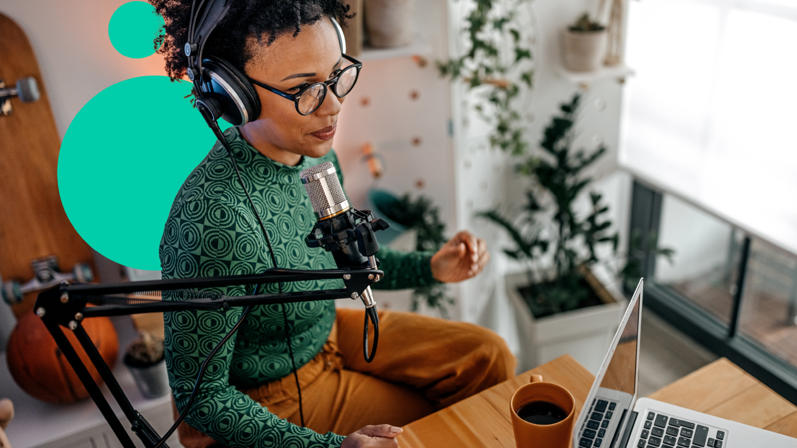 A podcaster seated at her computer with recording equipment